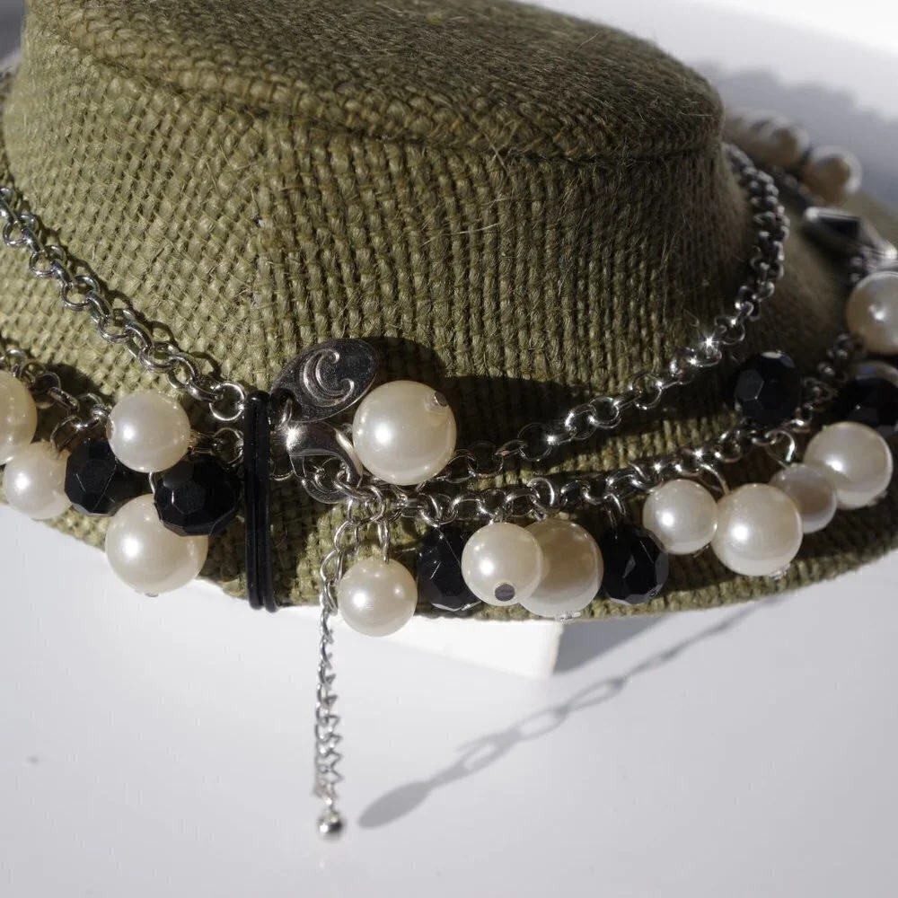 Women`s silver tone faux pearl black necklace.